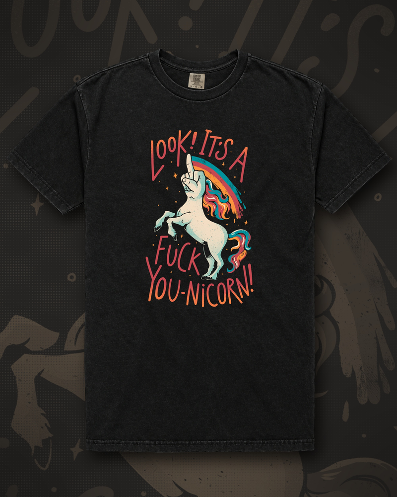 White unicorn rearing up and raising a middle finger in front of a rainbow, beside the words Look It's A Fuck You-nicorn graphic on black t-shirt – F-You Unicorn Tee by CREEPTEE