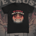 Chubby bear holding a glowing pizza slice graphic on black t-shirt – In Pizza We Crust Tee by CREEPTEE