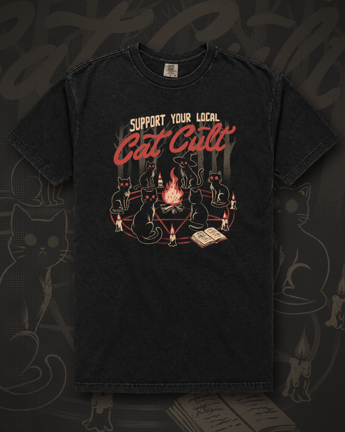 Black cats with glowing eyes seated around a fire on a pentagram lined with candles and an open book, under the words Support Your Local Cat Cult graphic on black t-shirt – Support Your Local Cat Cult Tee by CREEPTEE