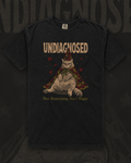Chubby cat in a red star-covered wizard hat and cape under the word Undiagnosed graphic on black t-shirt – Undiagnosed But Something Ain't Right Tee by CREEPTEE