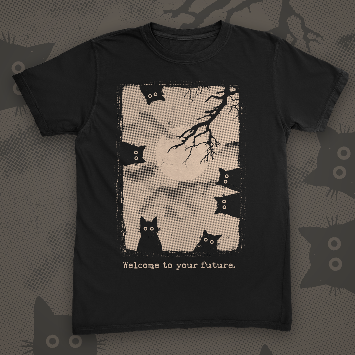Black t-shirt printed with a distressed halftone panel of a full moon and bare branch with six black cats peeking in from the edges, captioned Welcome to your future